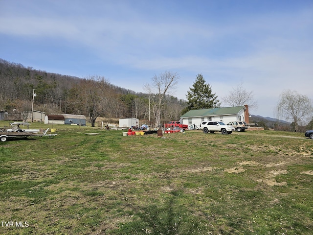 view of yard featuring a view of trees