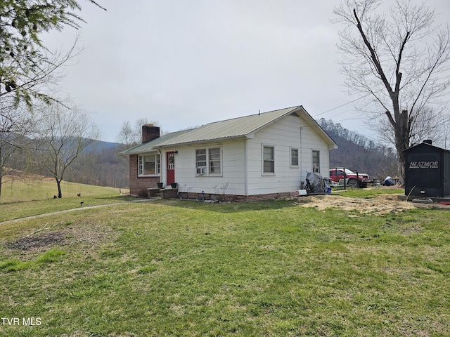 view of front facade with a front lawn and a chimney