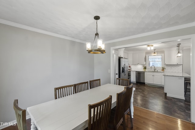 dining space featuring a notable chandelier, dark wood-type flooring, and ornamental molding