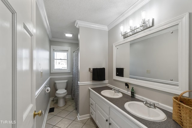 bathroom with a textured ceiling, toilet, crown molding, and a sink