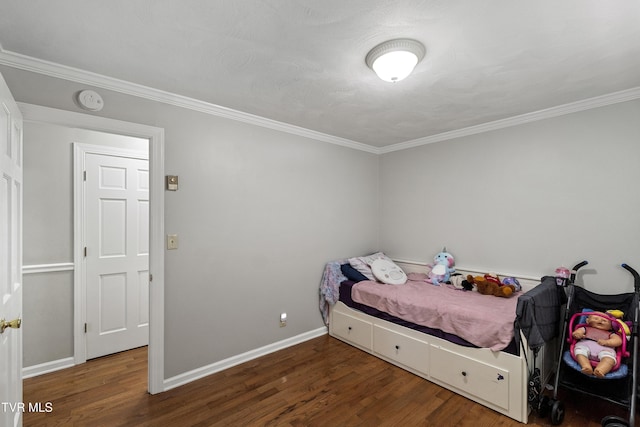 bedroom with baseboards, wood finished floors, and crown molding