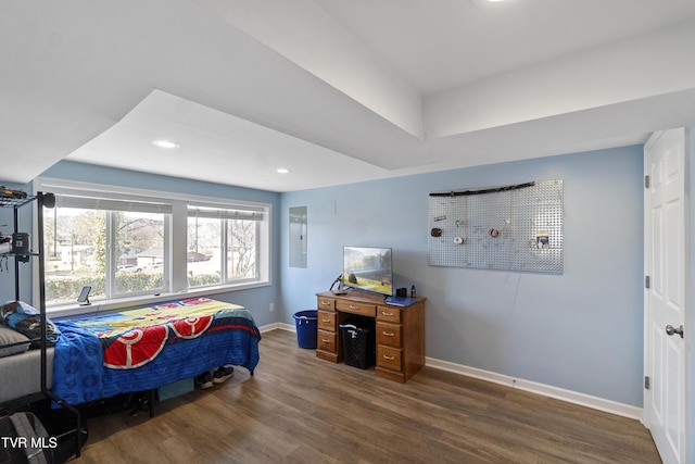 bedroom featuring recessed lighting, baseboards, electric panel, and wood finished floors