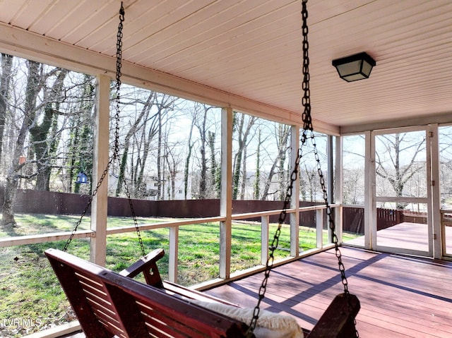 wooden deck with a lawn and fence