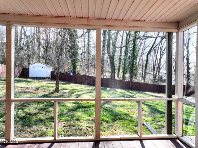 view of yard with a storage shed, an outbuilding, and a fenced backyard