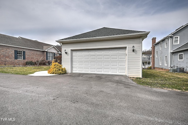 garage featuring aphalt driveway