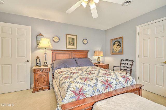 bedroom with ceiling fan, visible vents, and light carpet