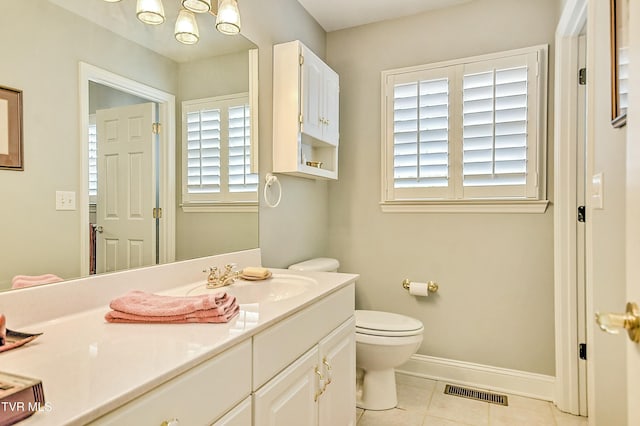 bathroom with vanity, baseboards, visible vents, tile patterned floors, and toilet