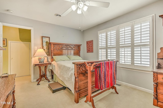 carpeted bedroom featuring a ceiling fan, baseboards, and visible vents