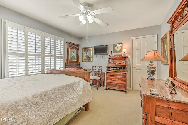 bedroom featuring light colored carpet and ceiling fan