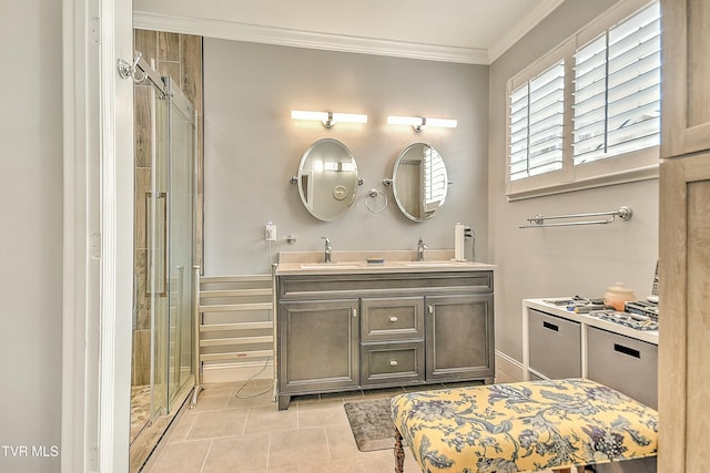 bathroom with double vanity, a sink, a stall shower, and ornamental molding