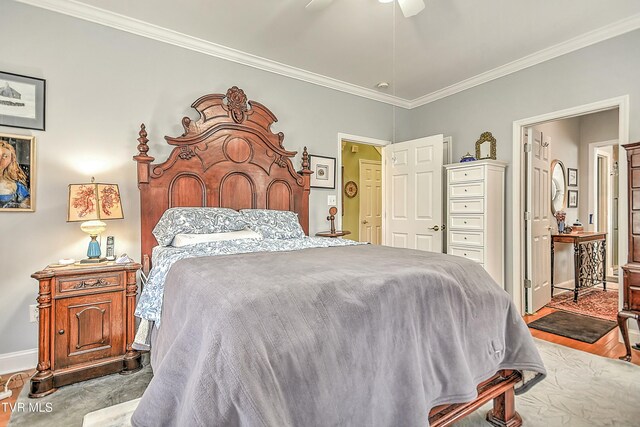 bedroom with ceiling fan, wood finished floors, baseboards, and ornamental molding