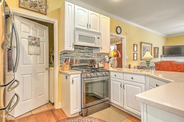 kitchen featuring backsplash, light wood-type flooring, light countertops, ornamental molding, and appliances with stainless steel finishes