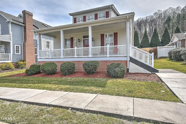 bungalow-style home with a front lawn and covered porch