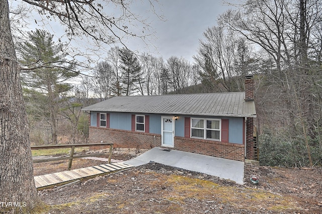 single story home with fence, brick siding, and a chimney