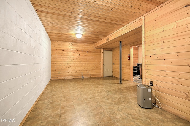 finished below grade area featuring wood walls and wood ceiling