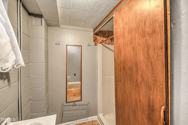 bathroom with concrete block wall