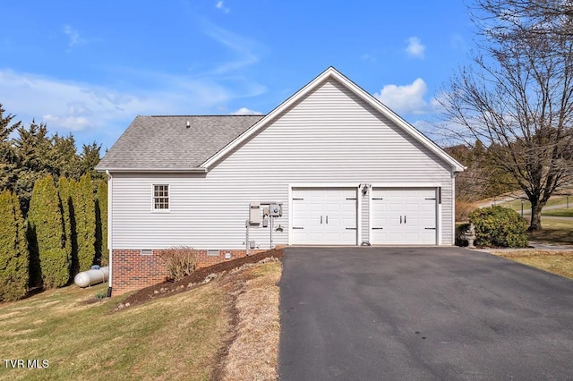 view of home's exterior with a lawn, aphalt driveway, an attached garage, a shingled roof, and crawl space