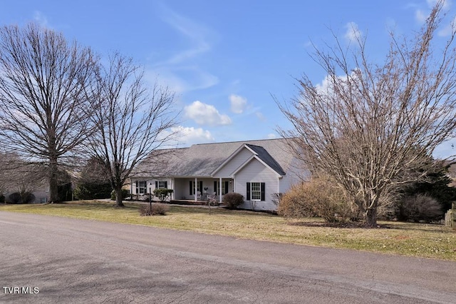 ranch-style house featuring a front yard and covered porch