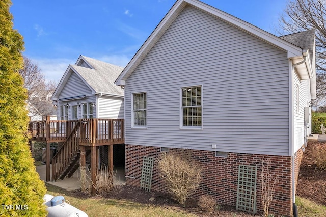 rear view of house with stairs and a deck