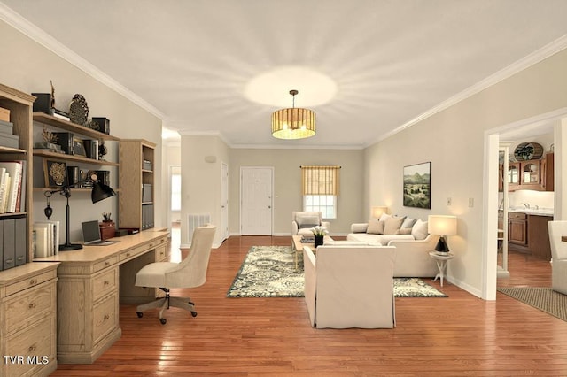 office featuring visible vents, crown molding, baseboards, and hardwood / wood-style flooring