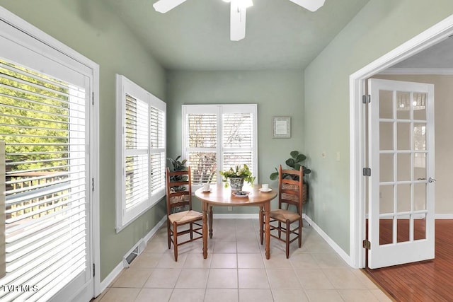 dining area featuring light tile patterned floors, visible vents, baseboards, and a ceiling fan