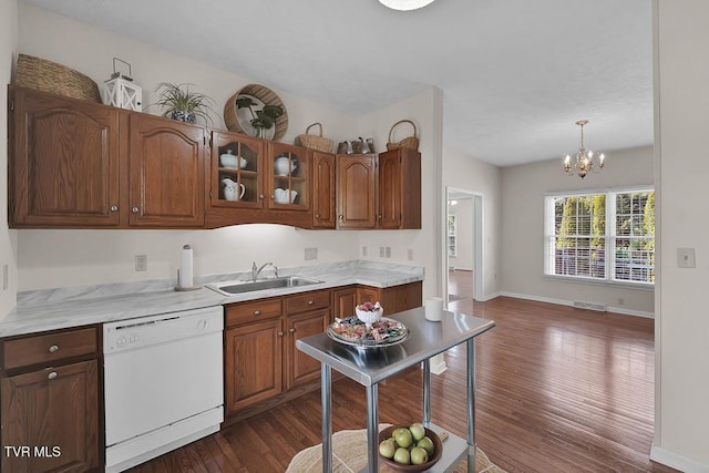 kitchen featuring visible vents, dark wood finished floors, an inviting chandelier, white dishwasher, and a sink