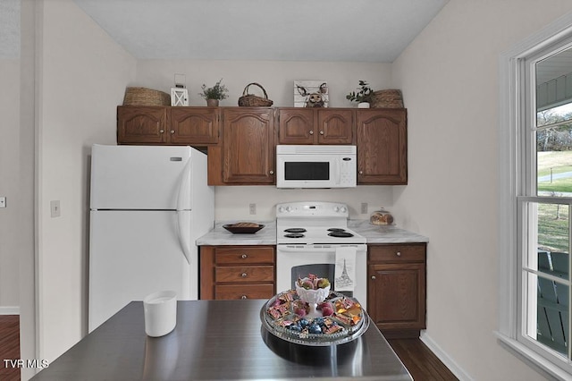 kitchen with white appliances, baseboards, dark wood-type flooring, and light countertops