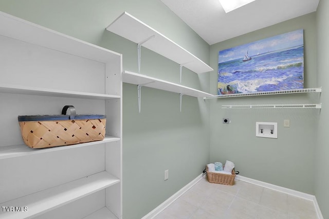 clothes washing area featuring laundry area, hookup for a washing machine, hookup for an electric dryer, and baseboards