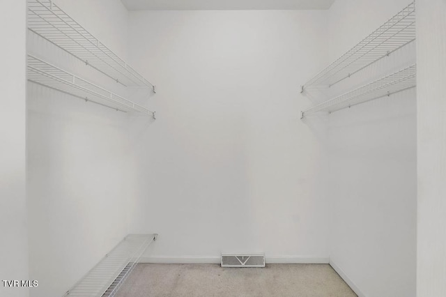 spacious closet featuring visible vents and carpet