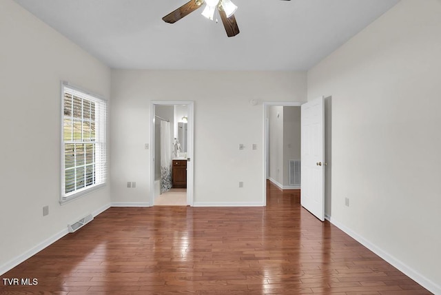 unfurnished bedroom featuring baseboards, visible vents, and wood-type flooring