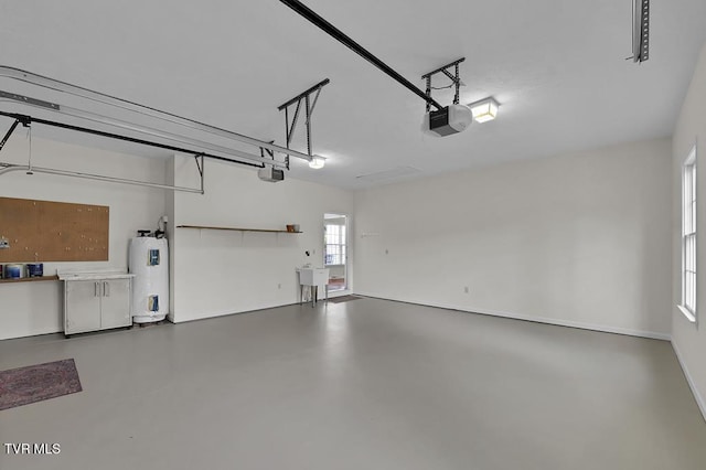 garage featuring a sink, electric water heater, and a garage door opener