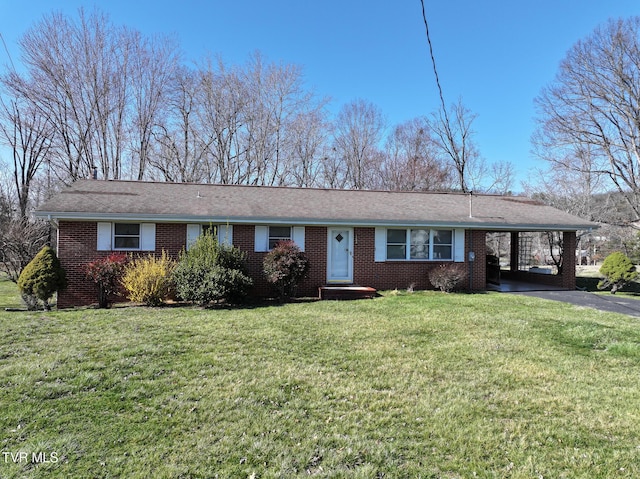 ranch-style house with aphalt driveway, an attached carport, brick siding, and a front lawn