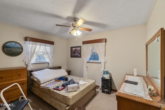 bedroom featuring a ceiling fan, light colored carpet, and baseboards