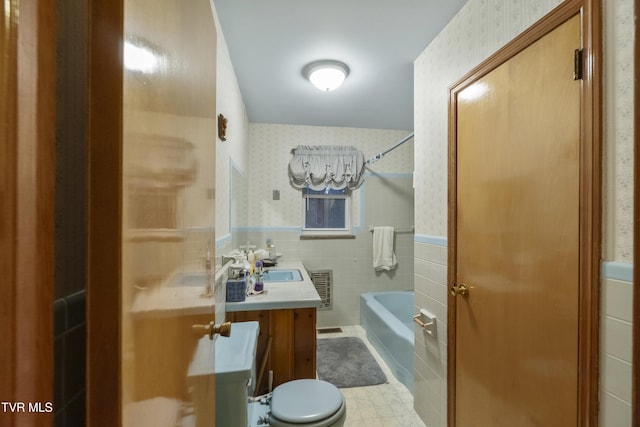 full bath featuring a wainscoted wall, shower / washtub combination, wallpapered walls, and tile walls