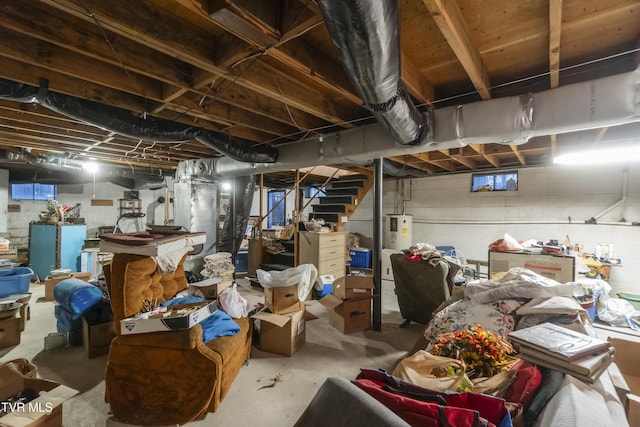 unfinished basement featuring stairway and water heater