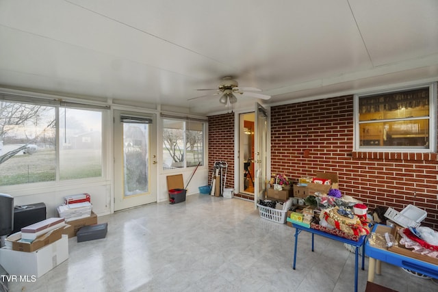 sunroom featuring a ceiling fan