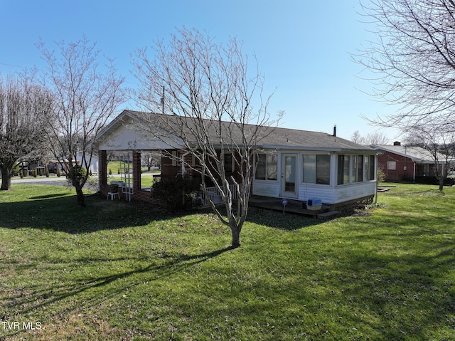 view of front of property with a front lawn and a sunroom