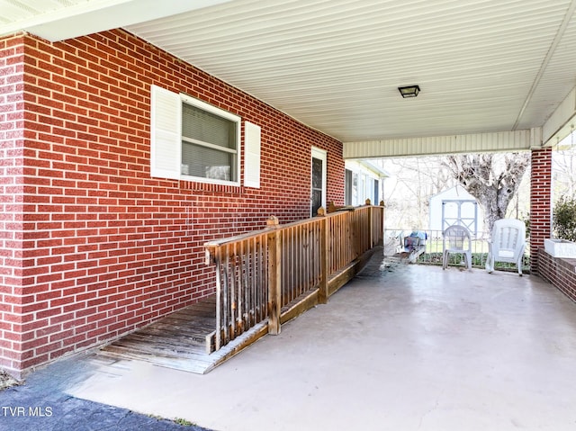 view of patio featuring a storage shed, an outbuilding, and a carport