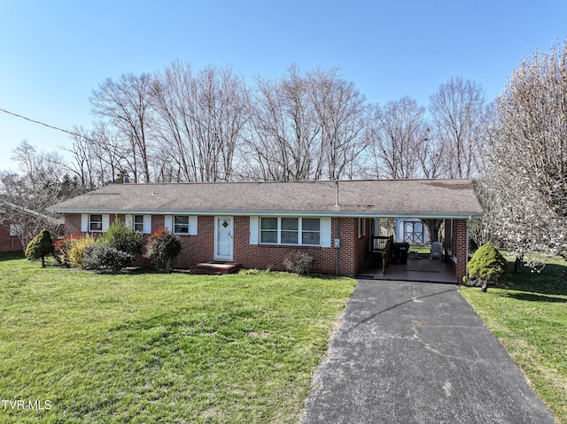 single story home with aphalt driveway, an attached carport, a front lawn, and brick siding