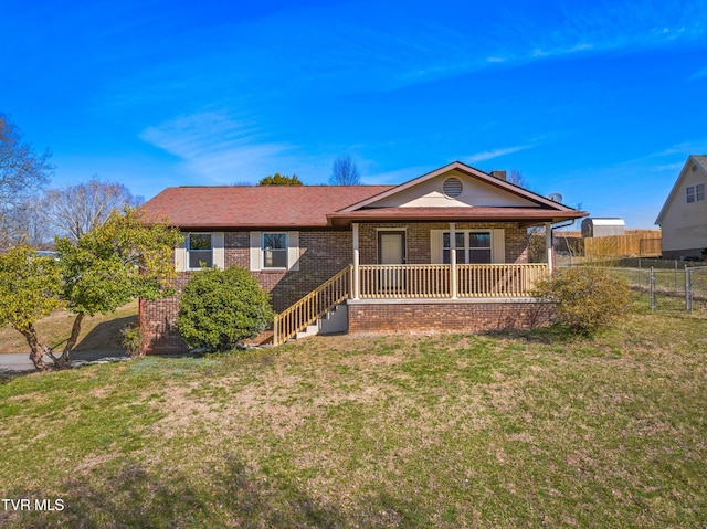 ranch-style home with brick siding, covered porch, a front lawn, and fence