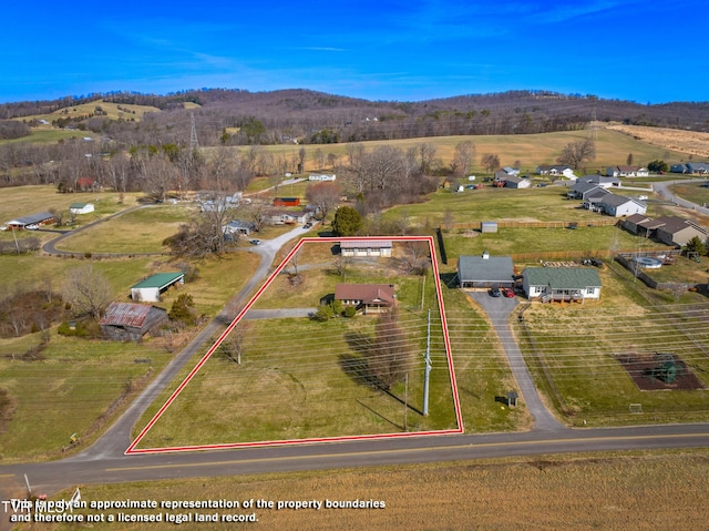 bird's eye view featuring a rural view and a mountain view