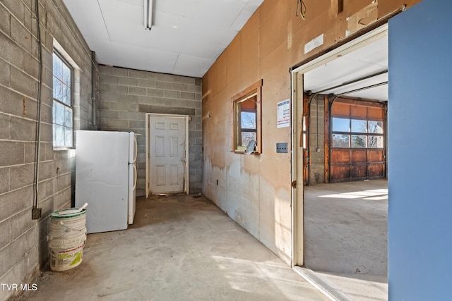 corridor with concrete block wall and concrete flooring