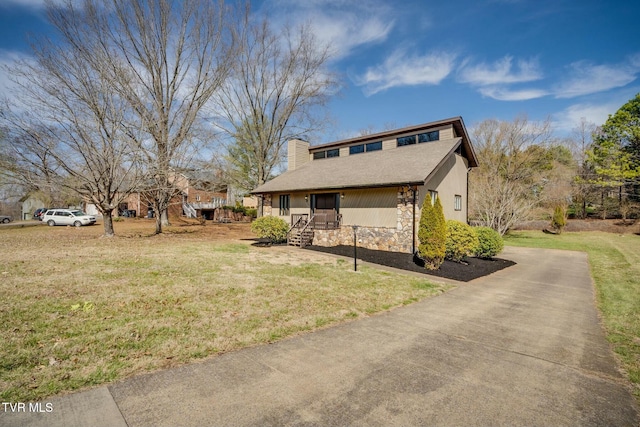 view of home's exterior featuring stone siding, a lawn, a chimney, and stucco siding