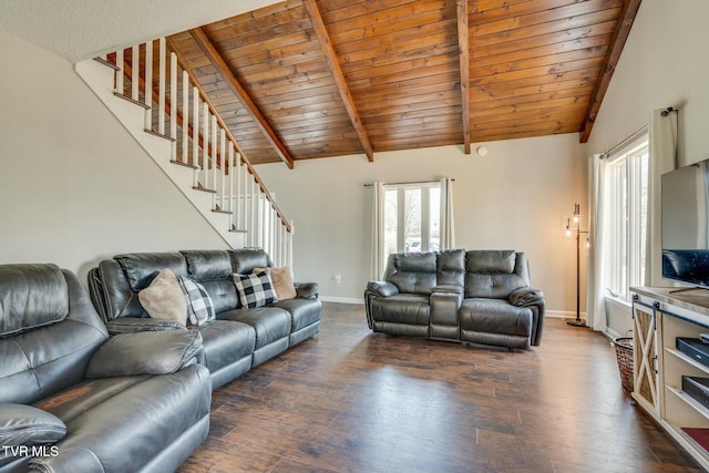 living room with stairs, dark wood-type flooring, beamed ceiling, and baseboards