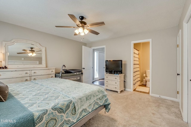 bedroom featuring baseboards, light carpet, a textured ceiling, and a ceiling fan