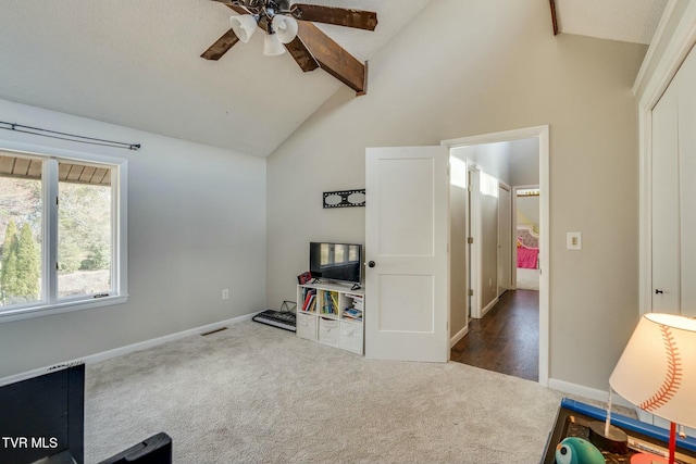 interior space featuring visible vents, carpet floors, beam ceiling, high vaulted ceiling, and a ceiling fan