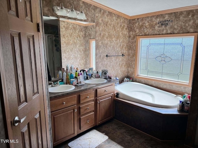 bathroom with double vanity, ornamental molding, a garden tub, and a sink