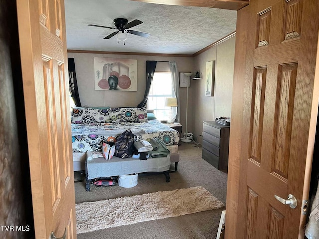 carpeted bedroom with ceiling fan, a textured ceiling, and ornamental molding