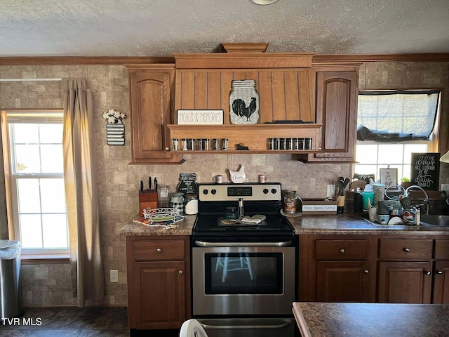 kitchen with dark countertops, stainless steel range with electric cooktop, a textured ceiling, and open shelves