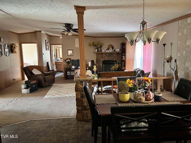 dining space featuring a wainscoted wall, a textured ceiling, ceiling fan, and crown molding